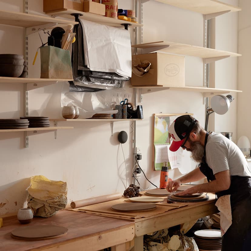 Fabio and Elisa Bernardi working together in their ceramics studio managing production and commissions